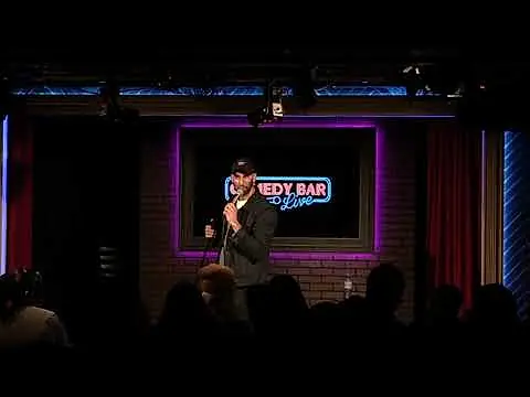 Comedian interacting with a South Asian audience member at Comedy Bar in Toronto during a show.
